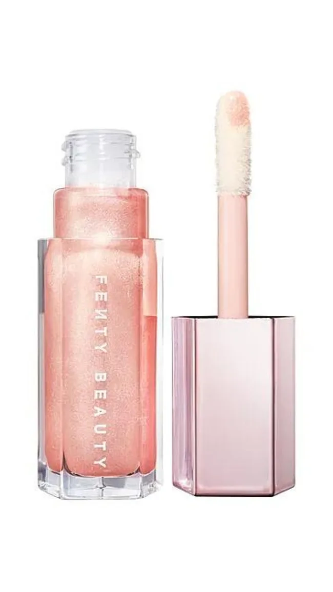 Fenty Beauty shimmer lip gloss with wand applicator, in a pink, reflective bottle.
