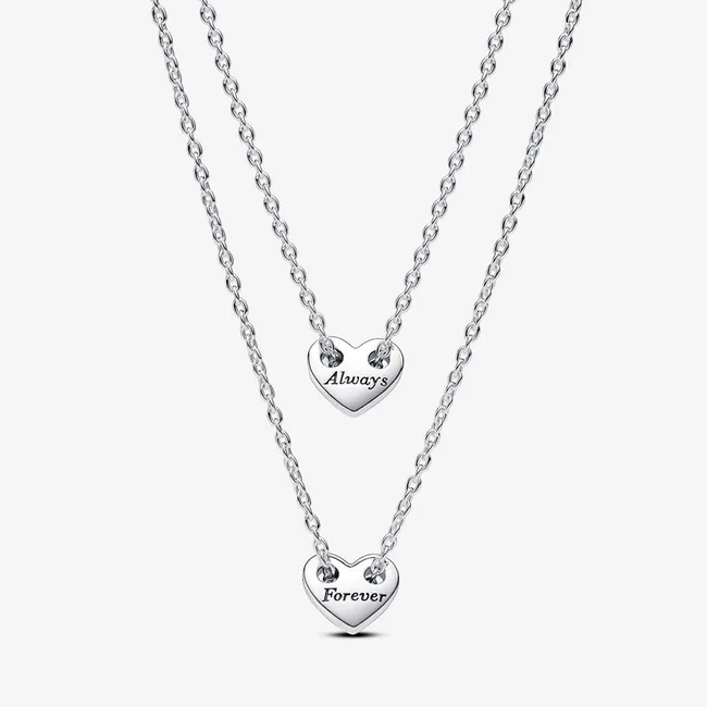 Two heart-shaped necklaces with engravings: "Always" on the top and "Forever" on the bottom, on silver chains.